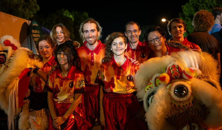 The dragon dance team gathered with the festival dragon at One Long Table