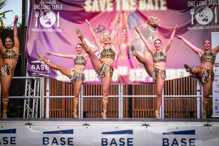Gold-costumed dancers performing on the One Long Table main stage