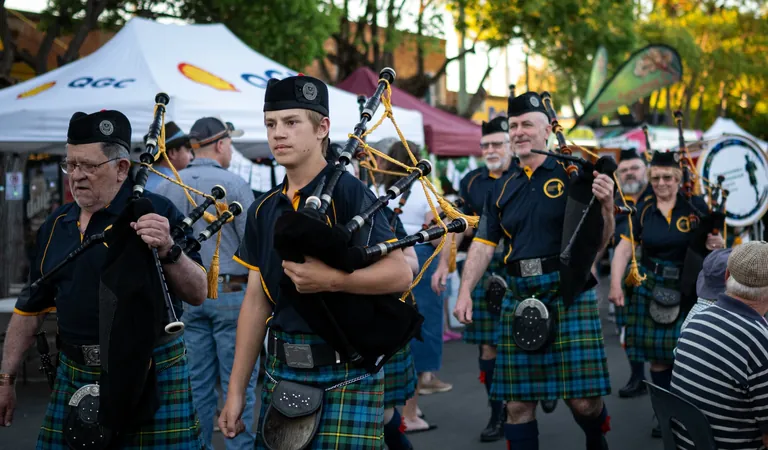 A pipe band marching through the One Long Table street festival